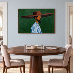 Green-background portrait on a pale blue dining room wall above an oval wooden table.