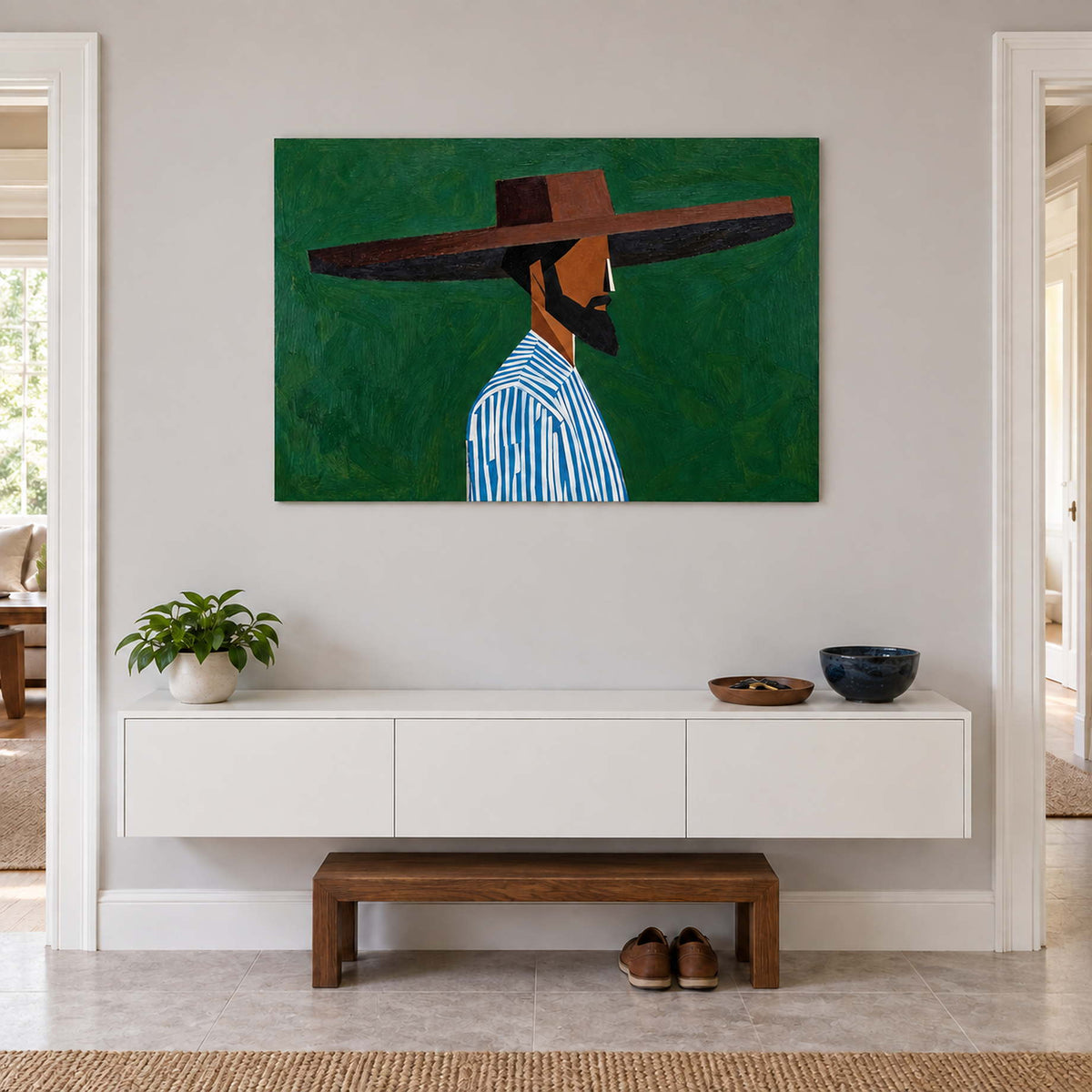 Green portrait above a floating white cabinet and a low wooden entryway bench.