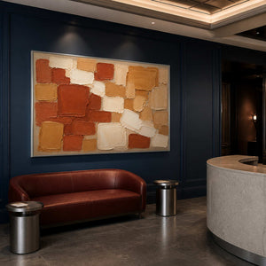 Terracotta, ochre, and cream painted blocks wall art in a contemporary commercial lobby.