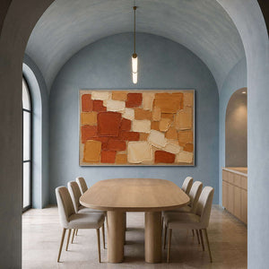 Terracotta, ochre, and cream painted blocks wall art in a contemporary dining room.