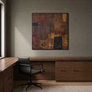 Textured burgundy and ochre painting with a black frame above a study desk.