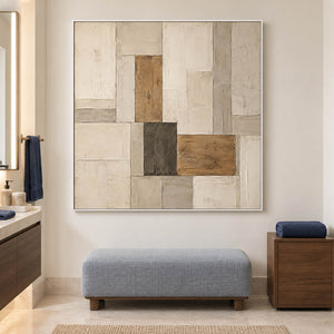 Textured ivory stone caramel and charcoal blocks in a quiet square composition, displayed in a bathroom dry area in a white frame.