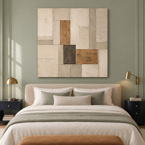 Textured ivory stone caramel and charcoal blocks in a quiet square composition, displayed in a bedroom without an outer frame.