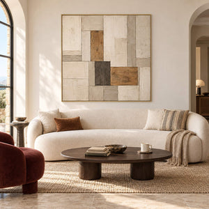 Textured ivory stone caramel and charcoal blocks in a quiet square composition, displayed in a living room in a gold frame.