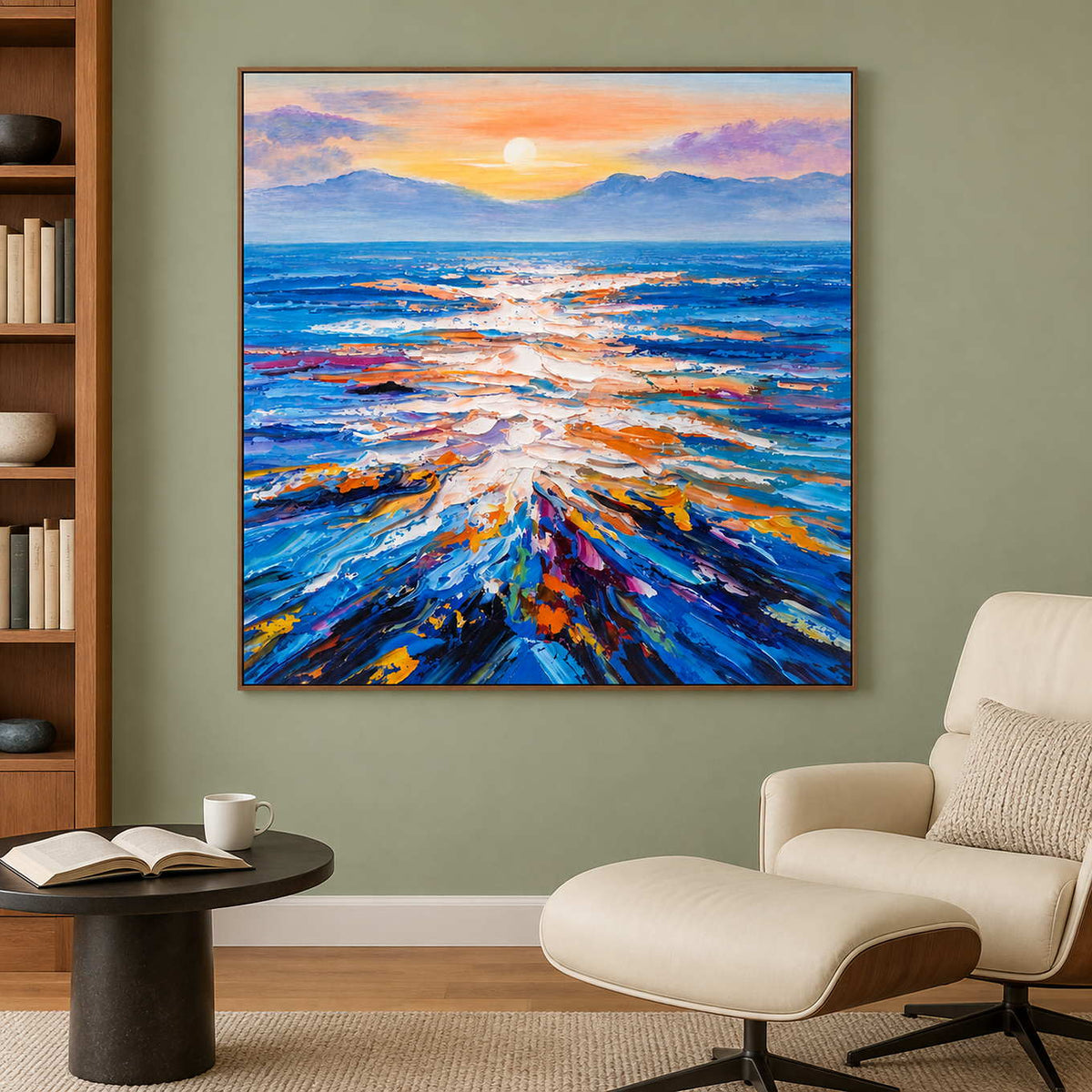 Blue sea and warm sky painting beside a cream lounge chair against a muted green wall.