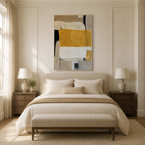 Warm ochre and cream abstract painting above a softly upholstered bed.