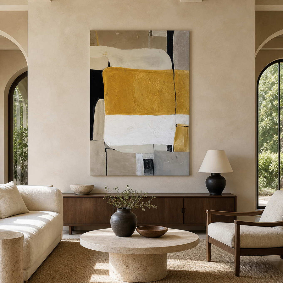 Ochre and cream abstract painting above a sideboard in an airy living room.