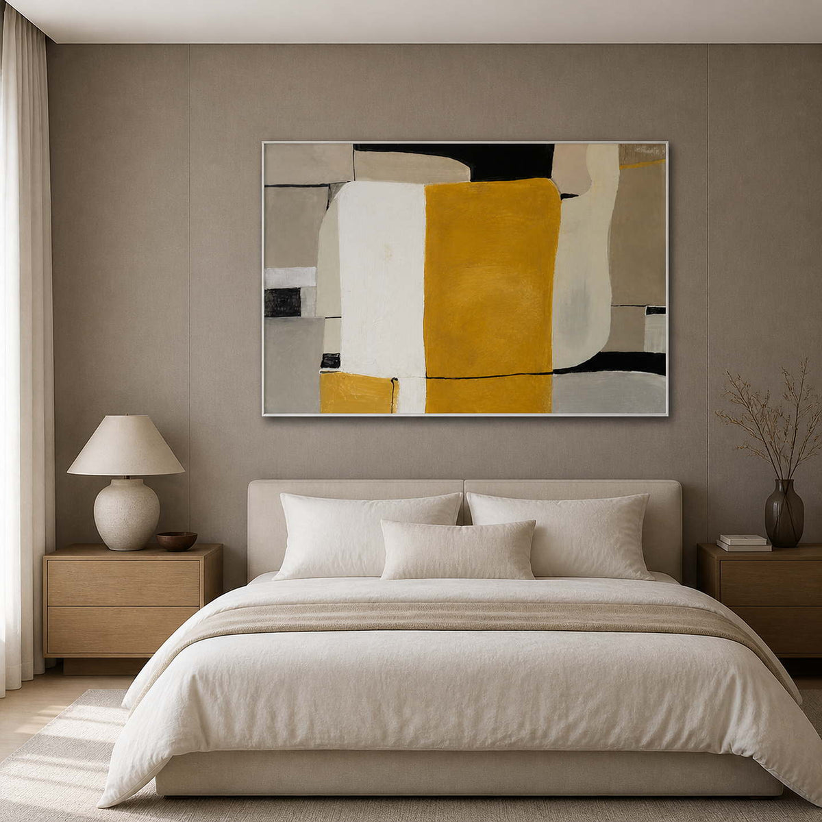 White framed horizontal abstract painting bringing ochre warmth above a softly upholstered bed.