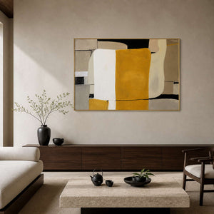 Gold framed abstract painting above a long sideboard in a quiet tea room.