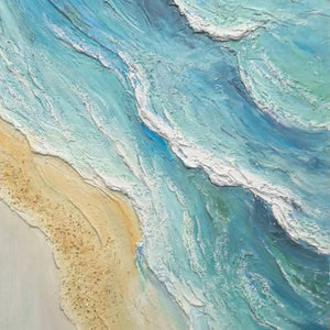 Close-up of ridged white wave edges across pale turquoise water and granular sand.