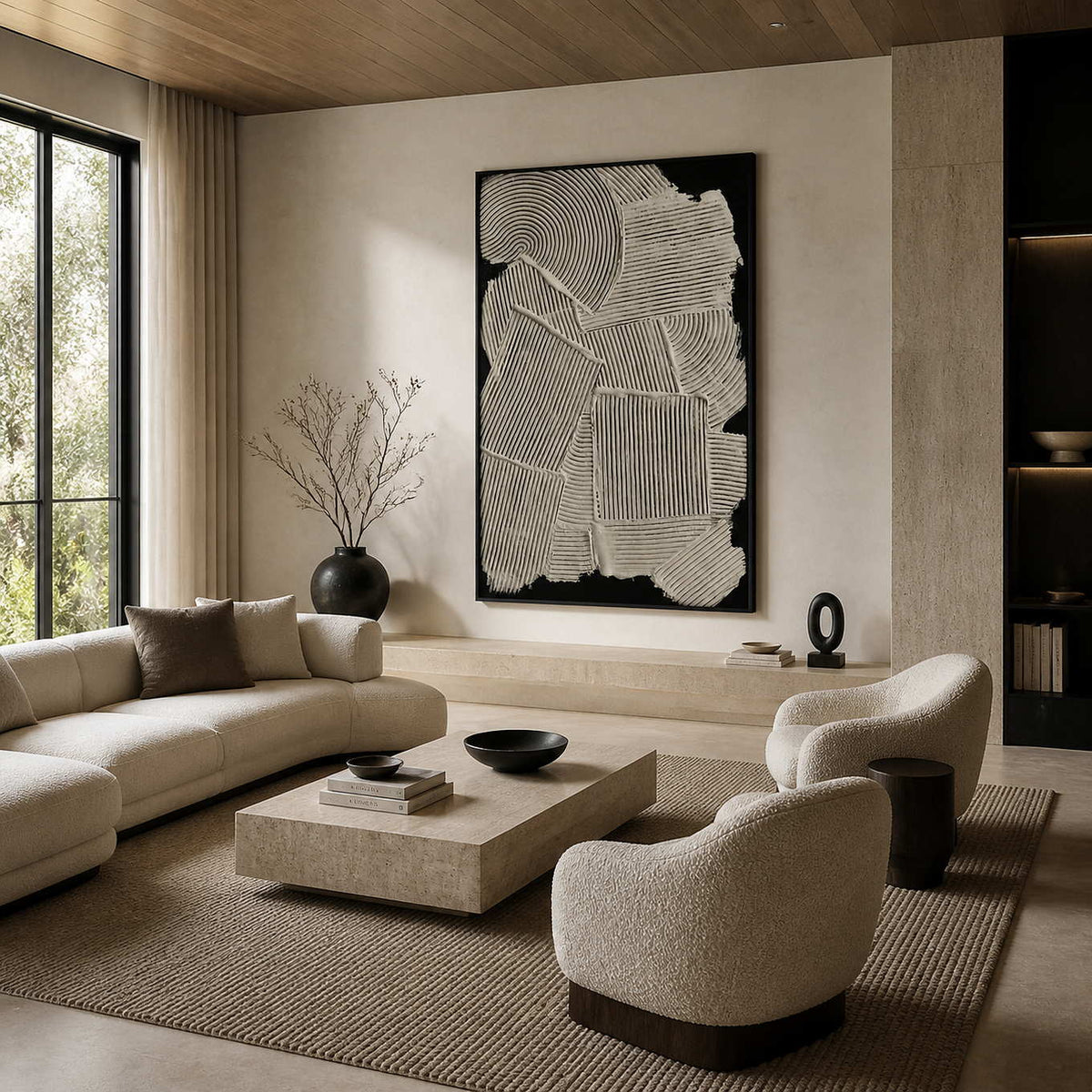 Black framed cream relief artwork above a stone ledge beside curved living room seating.