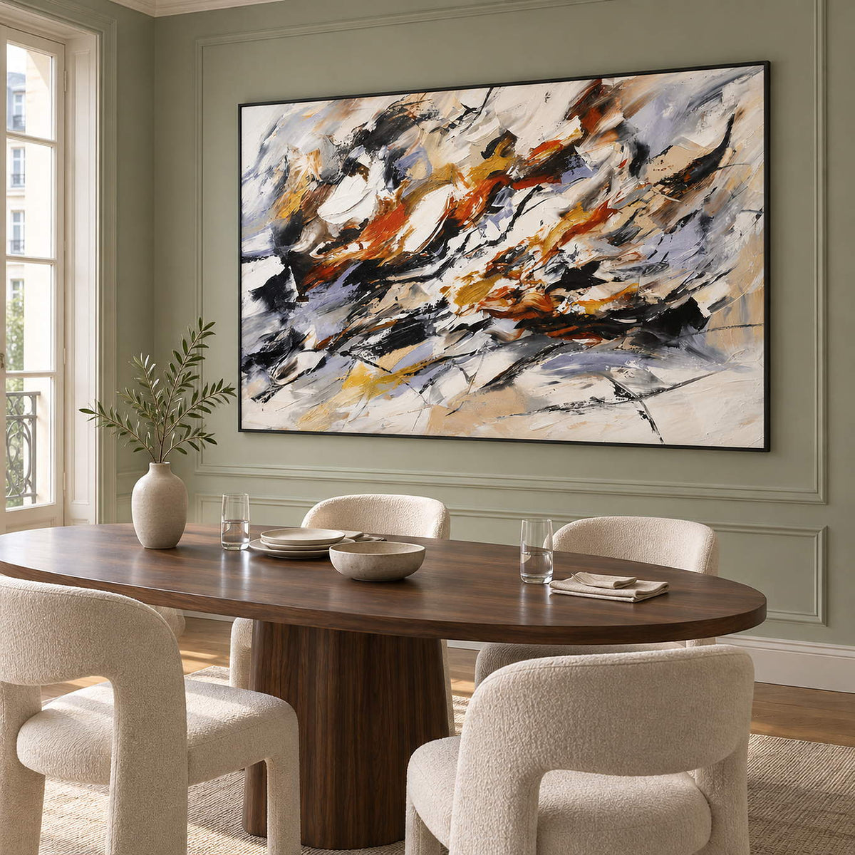 Hand-painted abstract artwork with black gestures and rust, ochre, ivory, and gray layers, displayed in a dining room in a black frame.