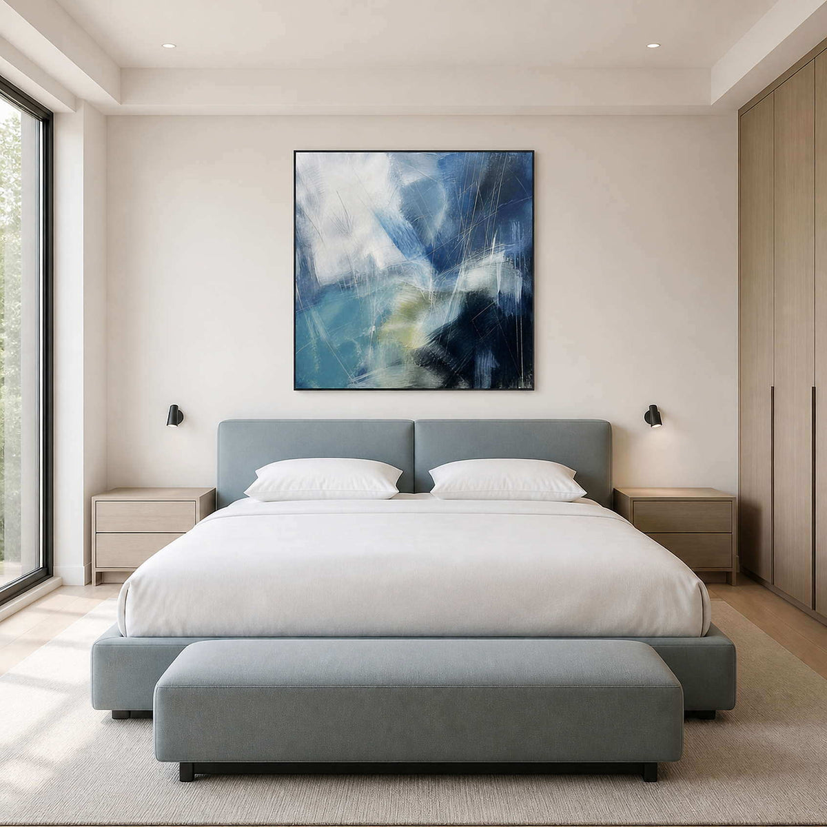 Cobalt and white abstract canvas centered above a modern bed.