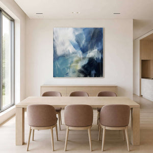 Textured blue wall art bringing cool movement to a light dining room.