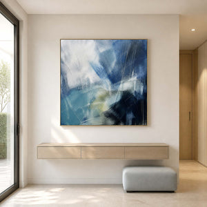 Square blue abstract painting above a floating entryway console.