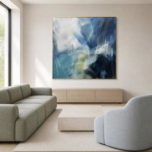 Blue textured abstract wall art in a bright contemporary living room.