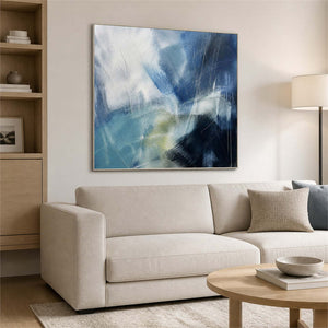 Energetic blue abstract artwork above a soft neutral living room sofa.