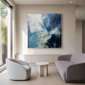 Expressive blue wall art paired with sculptural lounge seating.