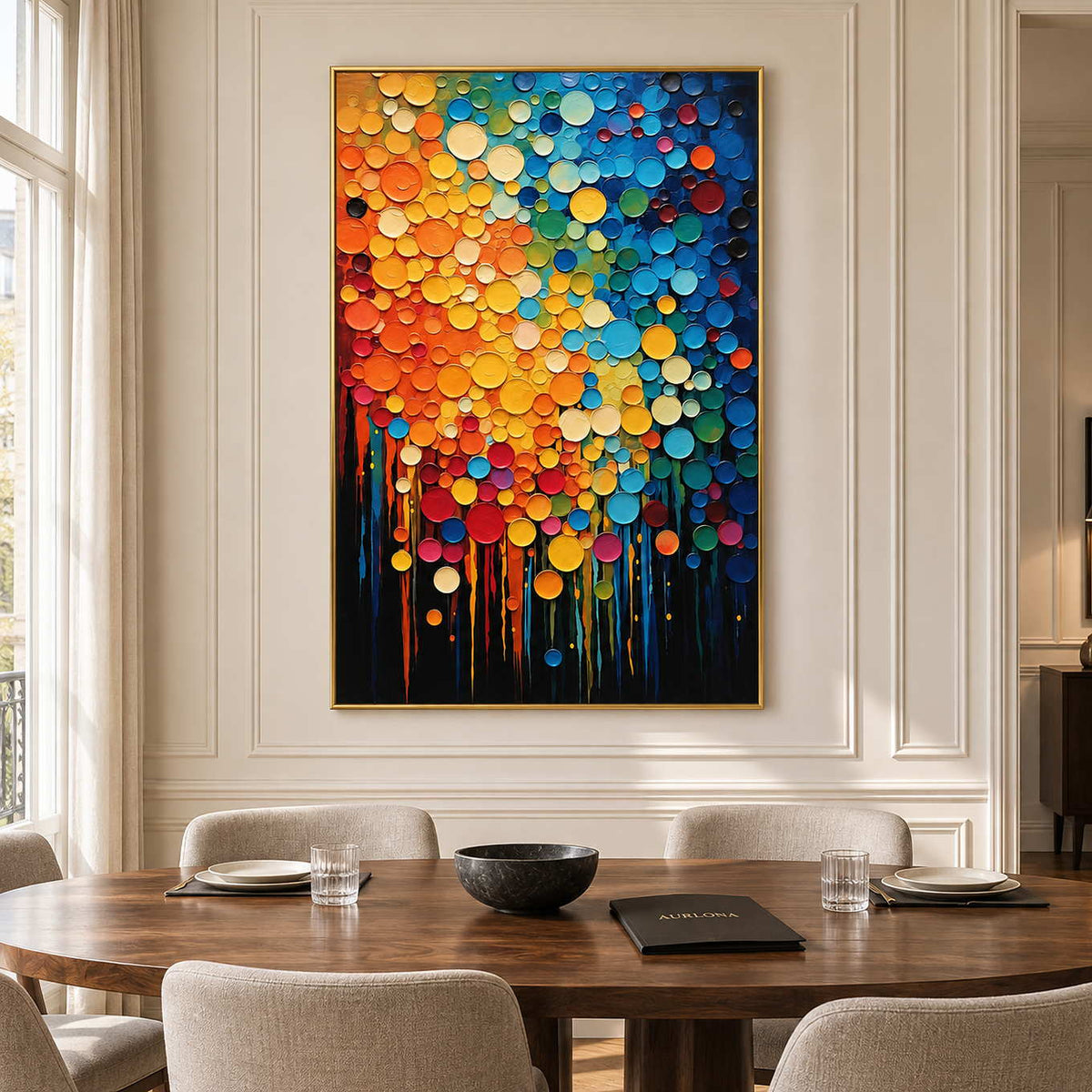 Bright circular abstract on a cream paneled dining-room wall above a wooden table.