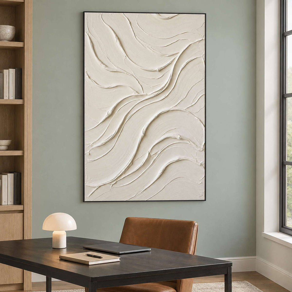 Black-framed ivory curves above a dark desk on a green wall.