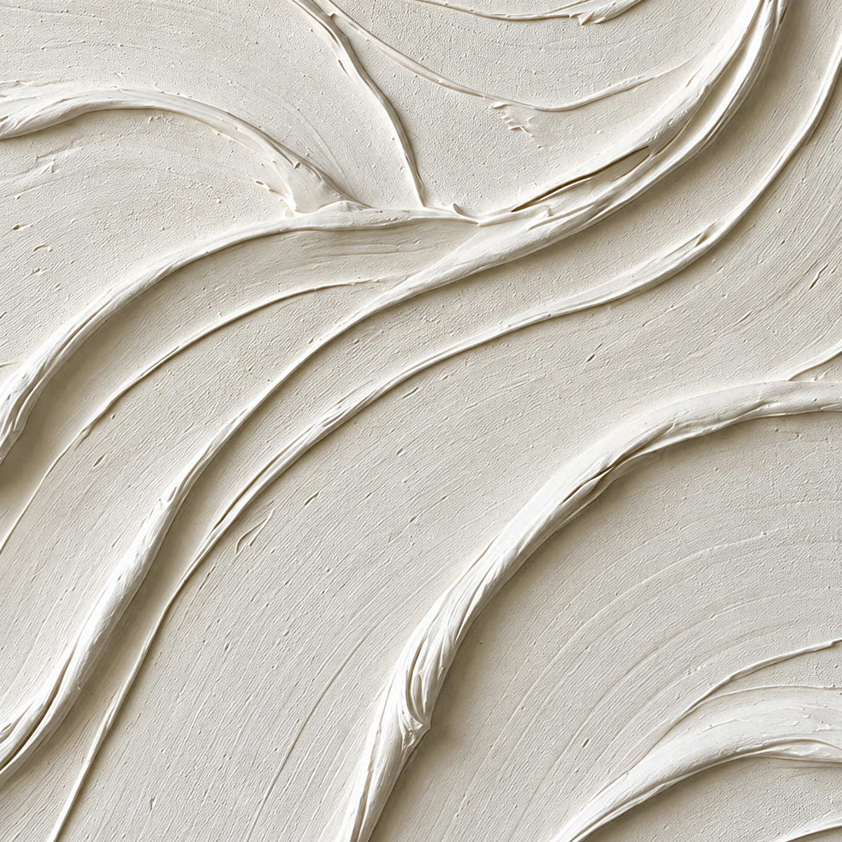 Close-up of broad ivory folds and narrow shadows at their edges.