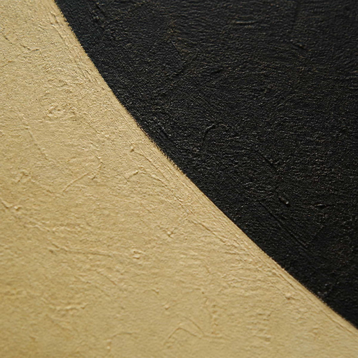 Close-up of warm ivory and near-black hand-painted geometric texture.
