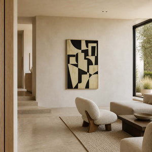 Black and ivory geometric wall art displayed in a warm stone living room.