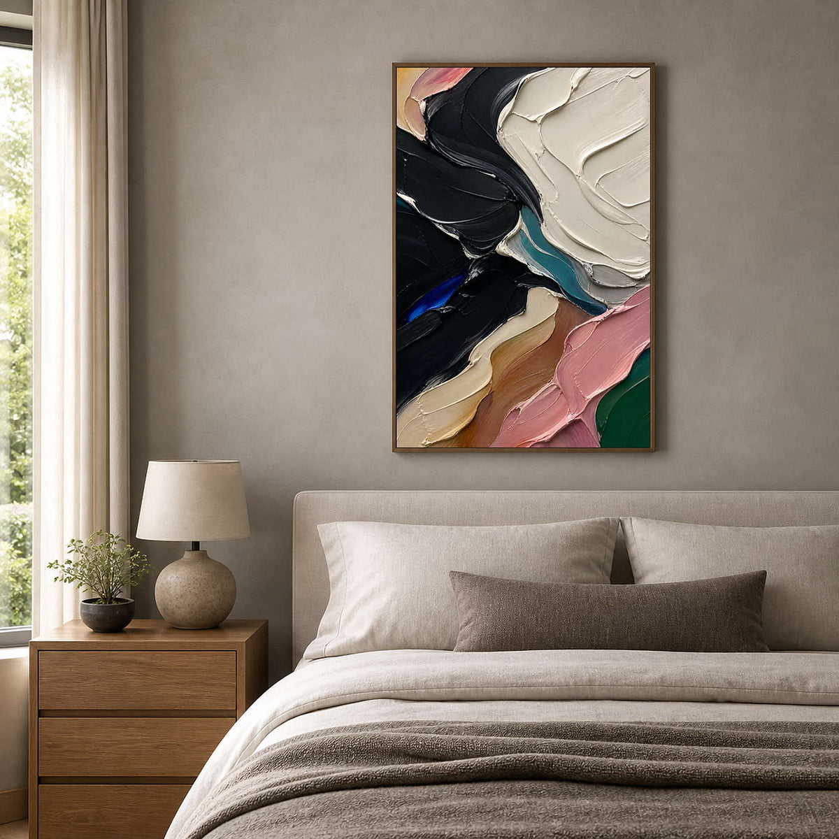 Textured black and pink canvas creates depth above a neutral bed.