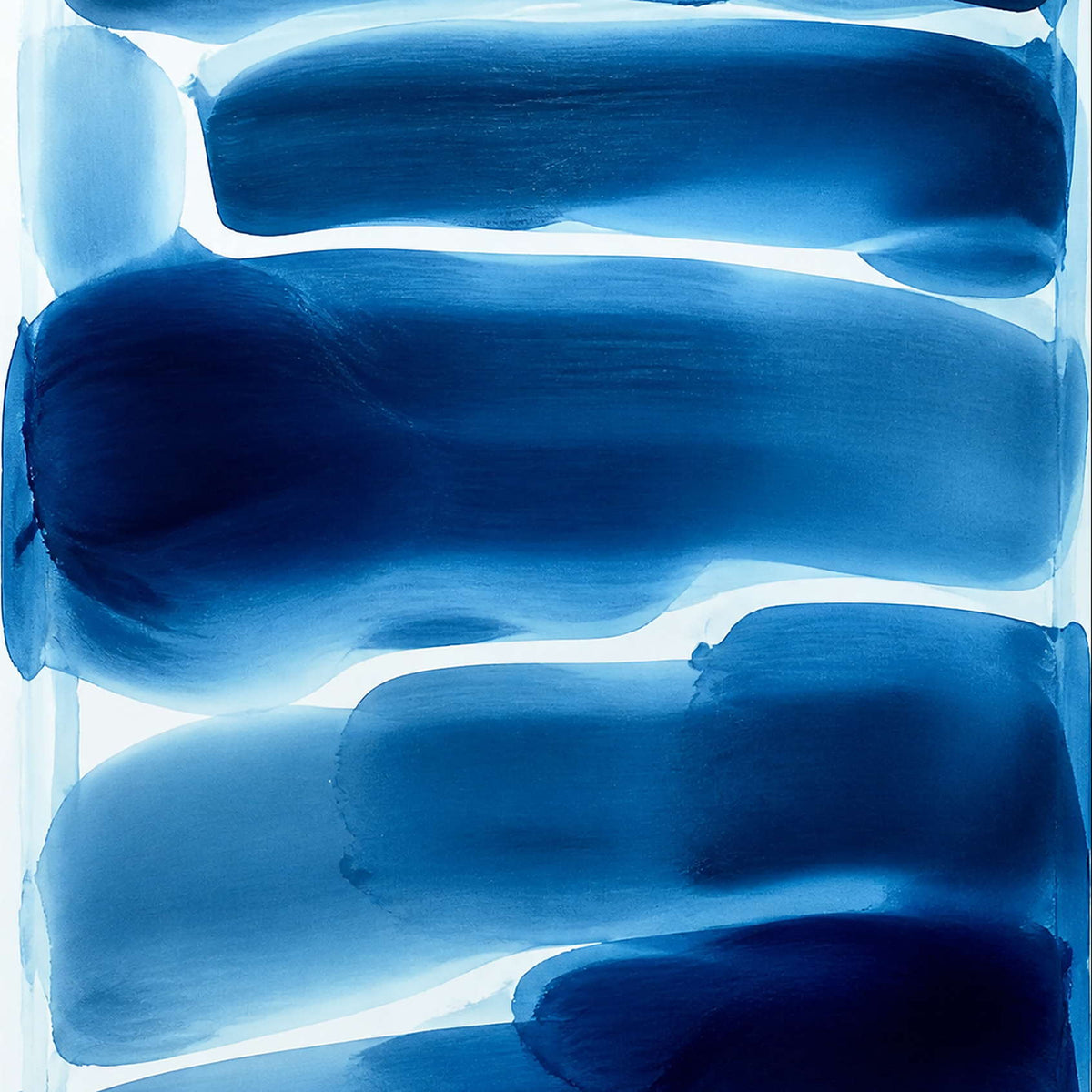 Close-up of fluid cobalt, ultramarine, sky blue, and white brushwork.
