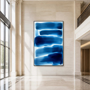 Large blue minimalist abstract painting displayed in a bright hotel lobby.