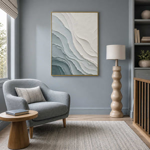 Textured coastal wall art displayed in a blue-gray reading lounge.