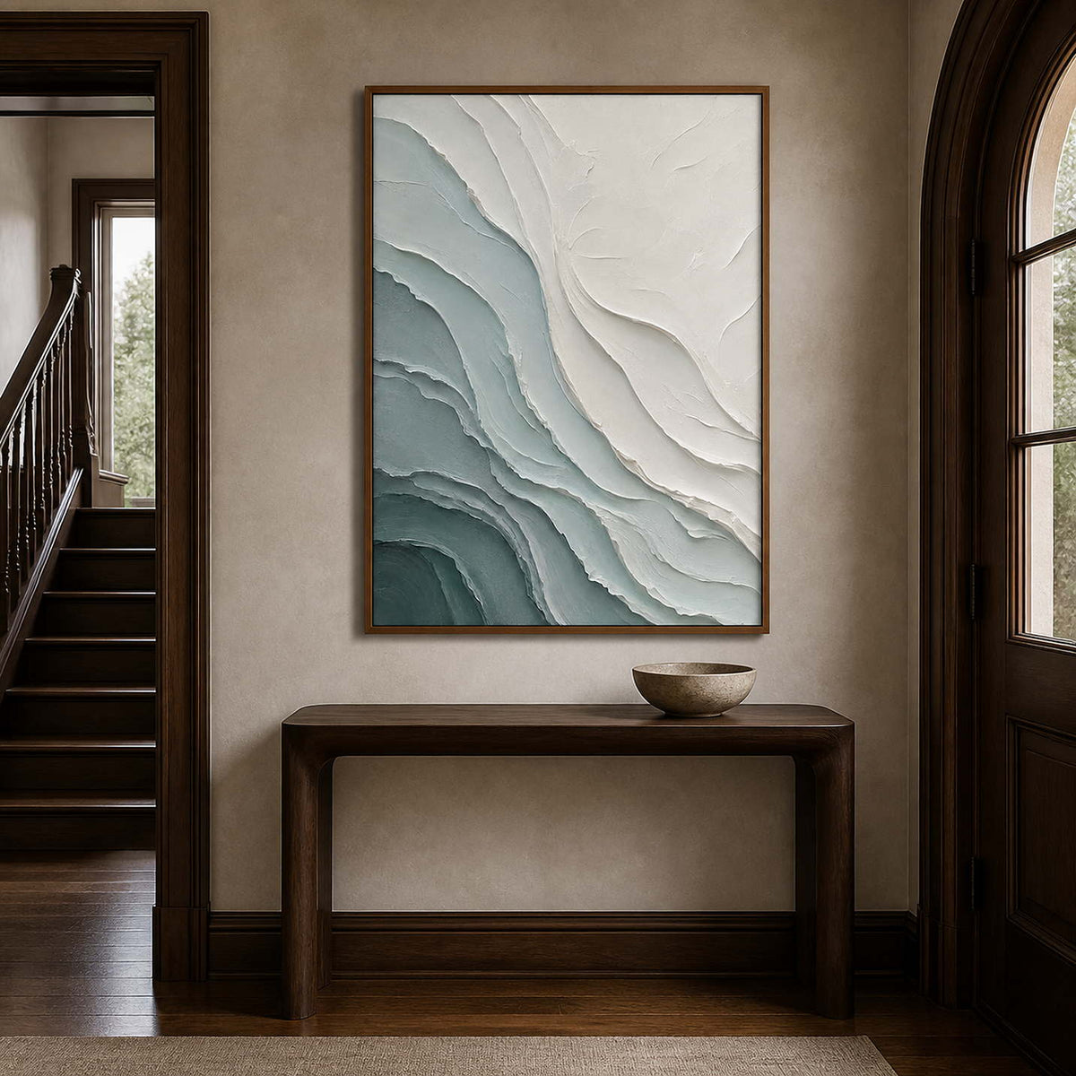 Textured coastal wall art displayed in a deep walnut entryway.
