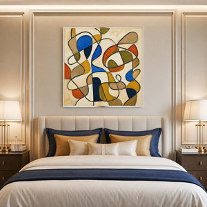 Cobalt and earth tone abstract wall art styled above a serene modern bed.
