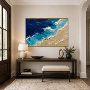 Vivid coastal wall art displayed above a modern entryway console.
