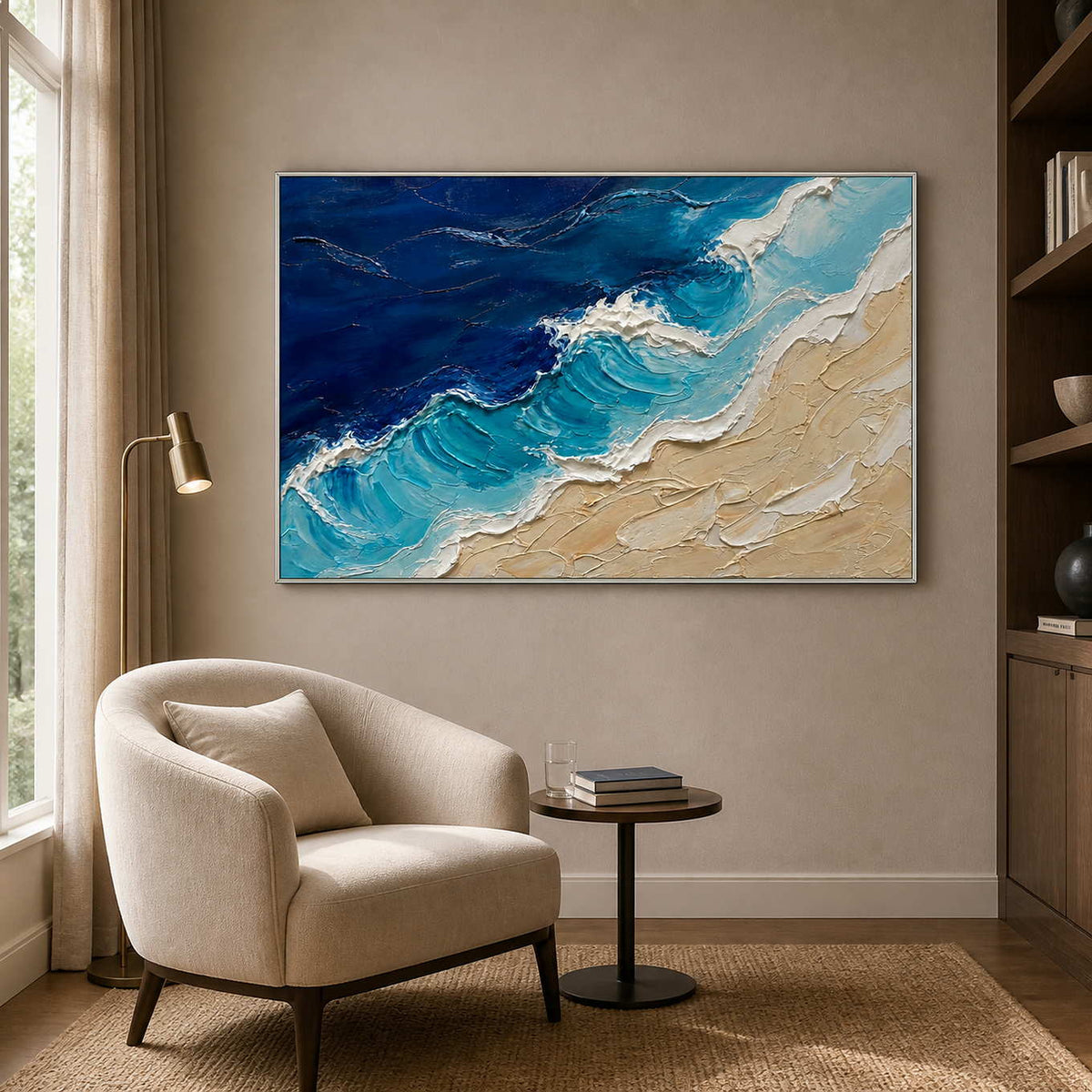 Blue and sand coastal artwork displayed beside a soft reading chair.