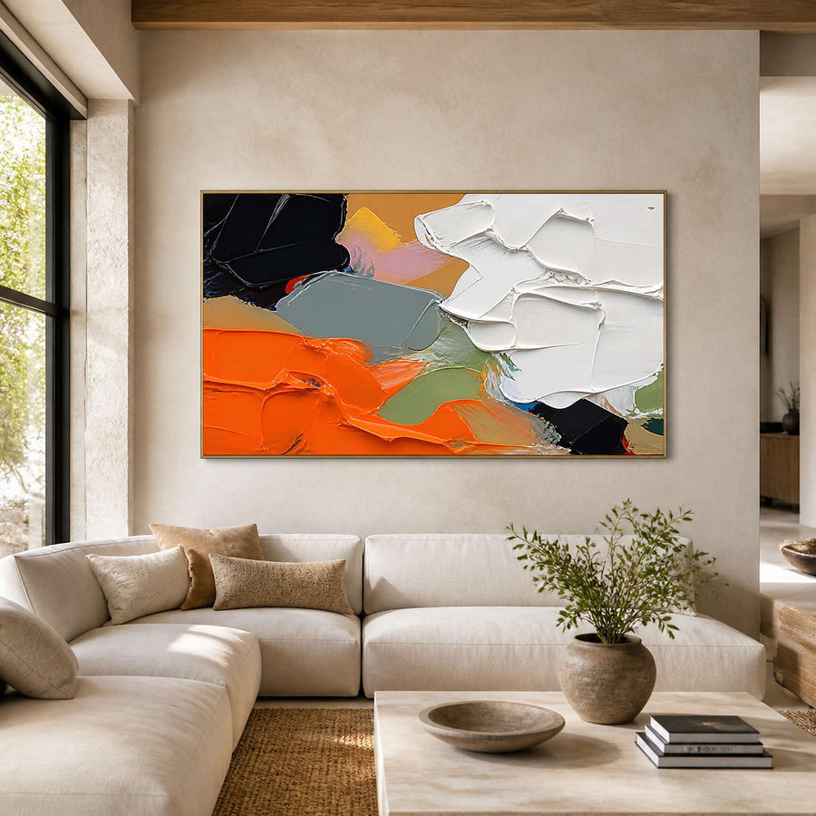 Orange, white, and black textured abstract wall art in a warm neutral living room.