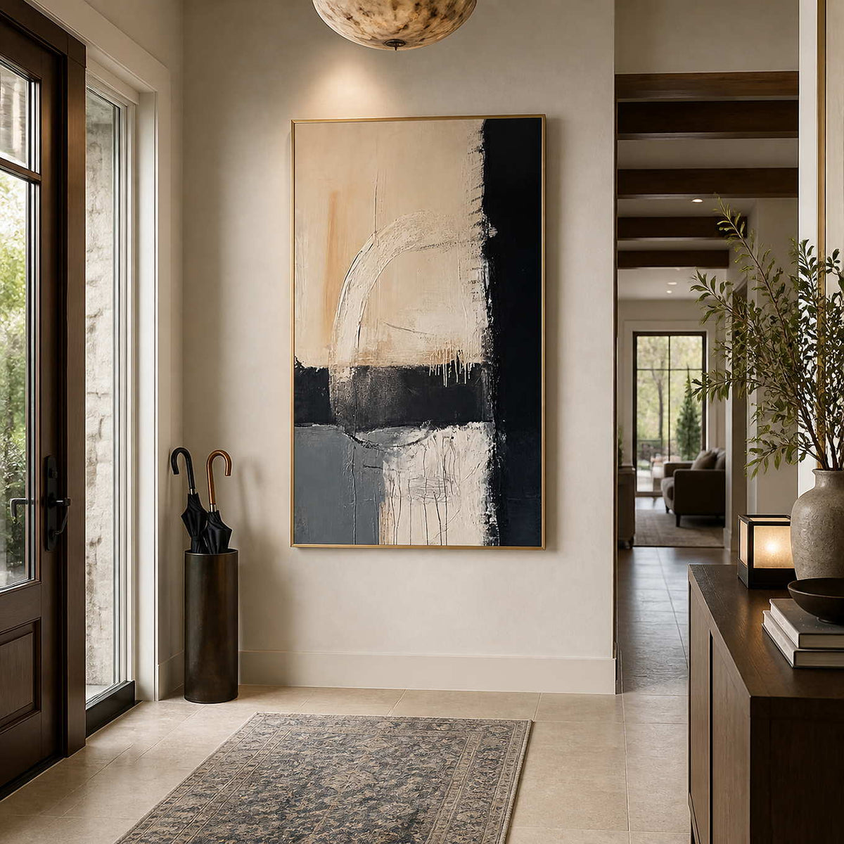 Where Day Meets Night in a gold frame on an entryway wall beside an umbrella stand and wood console.