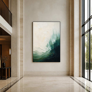 Textured green coastal painting displayed in a bright contemporary hotel lobby.