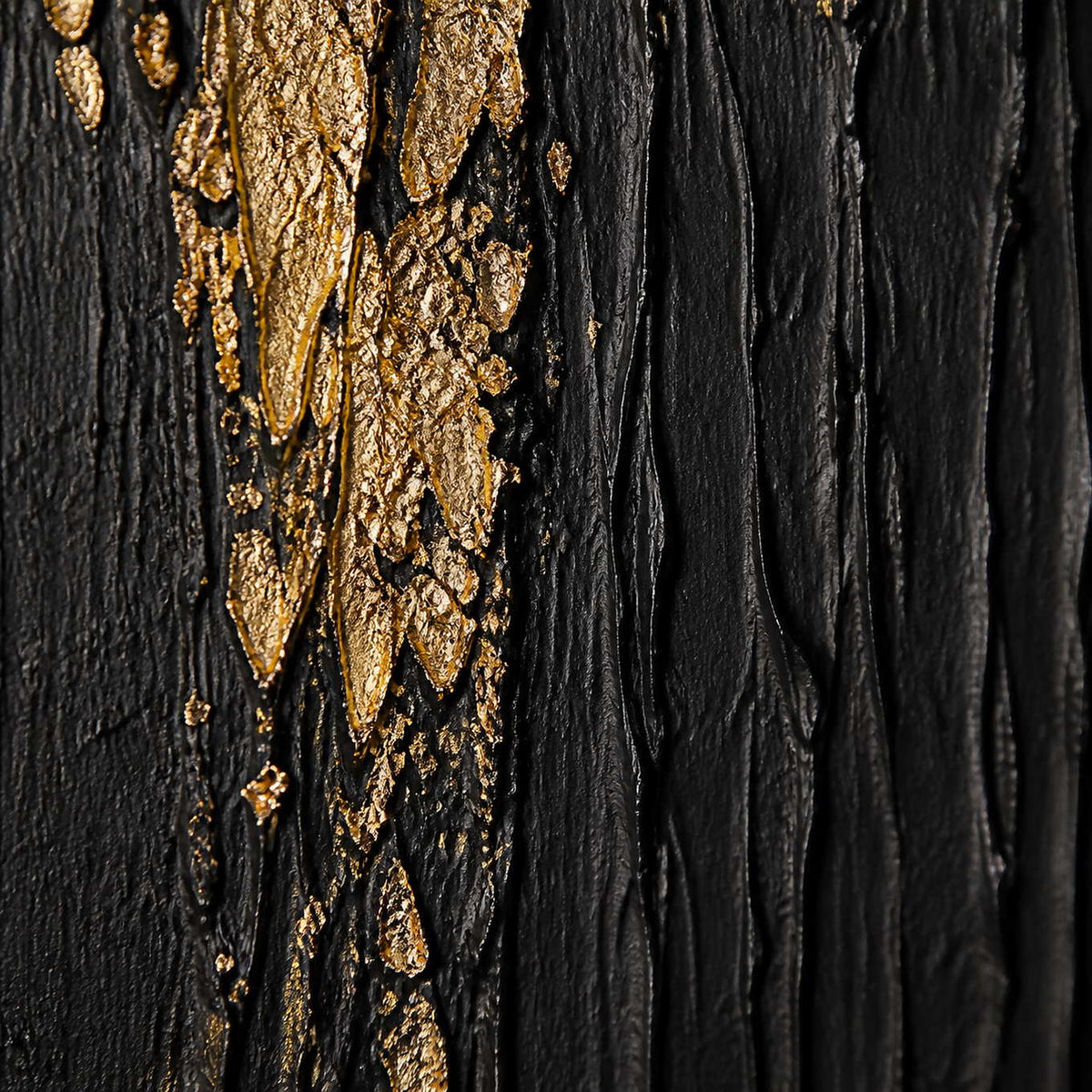 Close-up of thick black vertical texture meeting fractured gold relief.