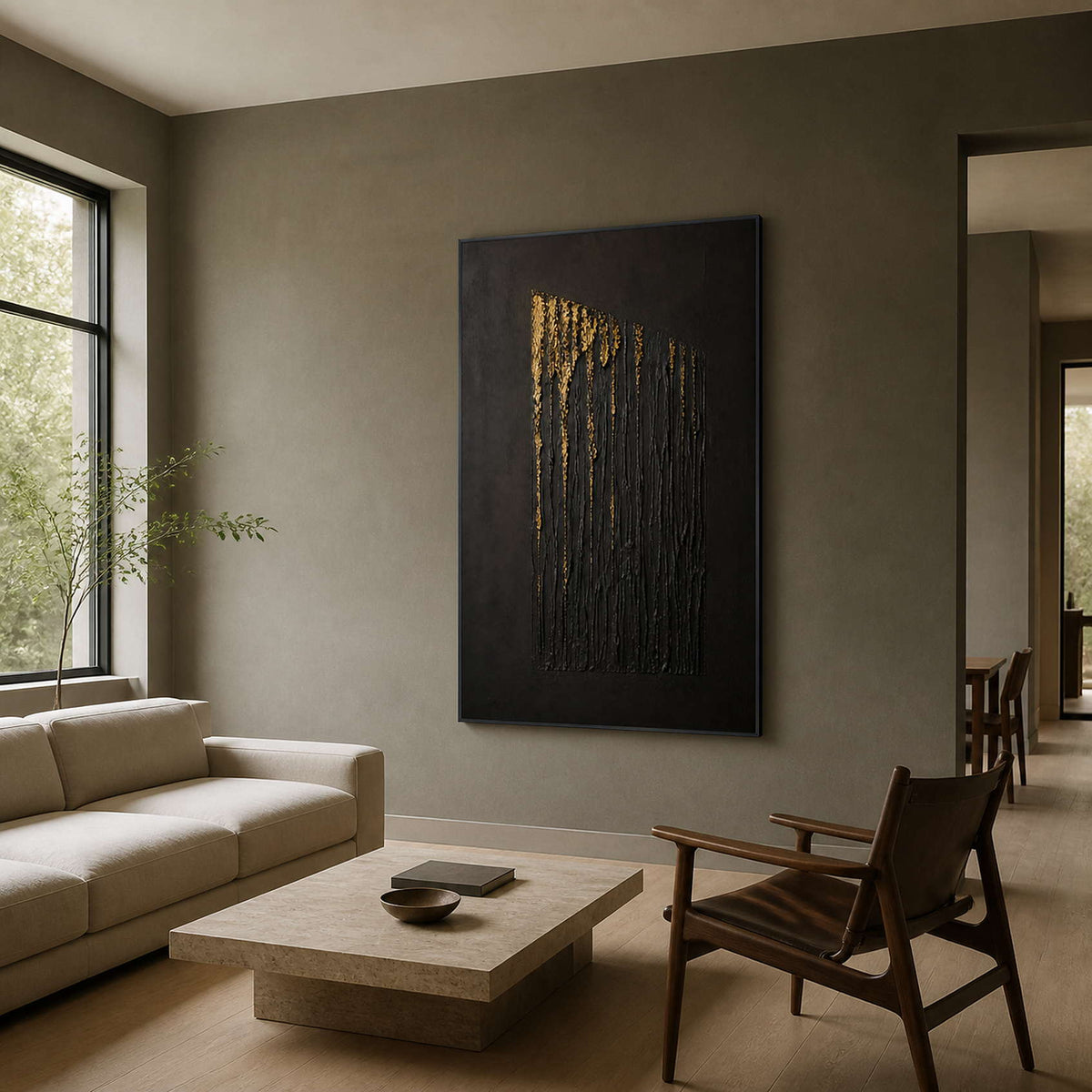 Black and gold wall art displayed in an olive-gray family living room.
