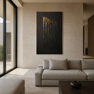 Black and gold textured wall art displayed in a warm ivory living room.