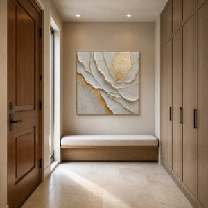 Gold and white botanical canvas displayed in a champagne-toned entryway.
