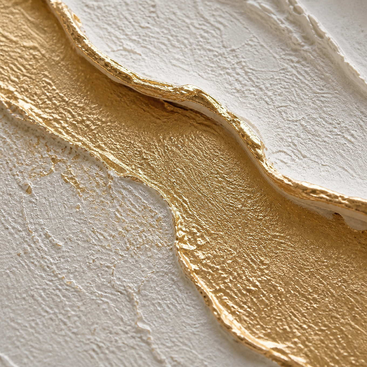 Close-up of raised ivory petals edged with luminous gold texture.