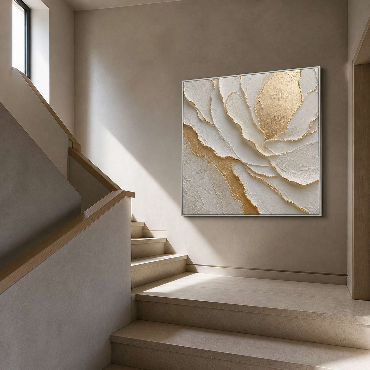Ivory and gold artwork viewed beside a warm gray residential staircase.