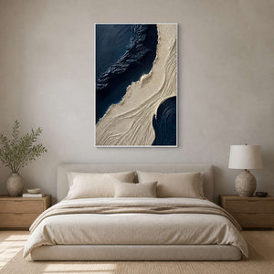 Navy and ivory vertical wall art displayed in a minimalist primary bedroom.