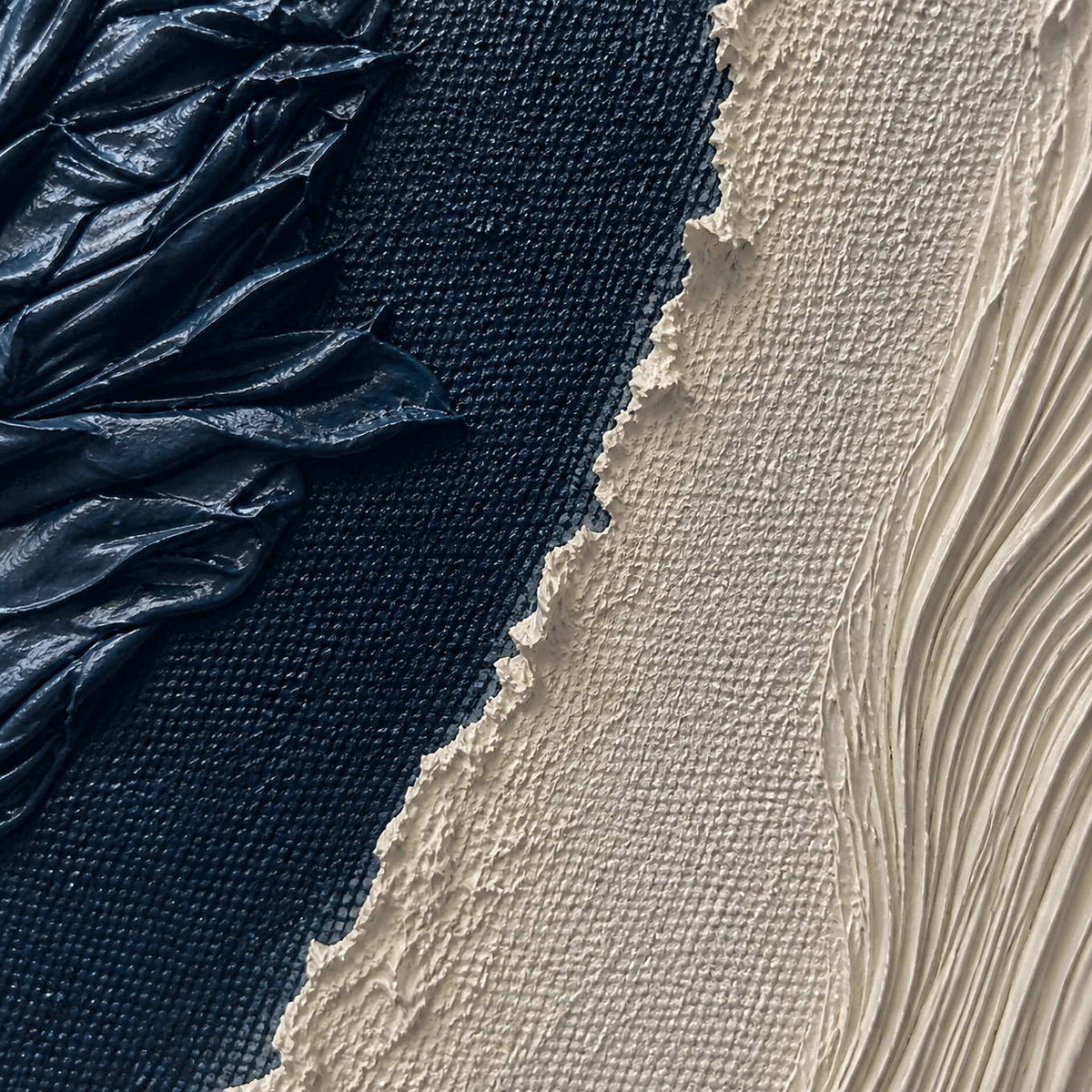 Close-up of folded midnight paint fine ivory ridges and rough texture.
