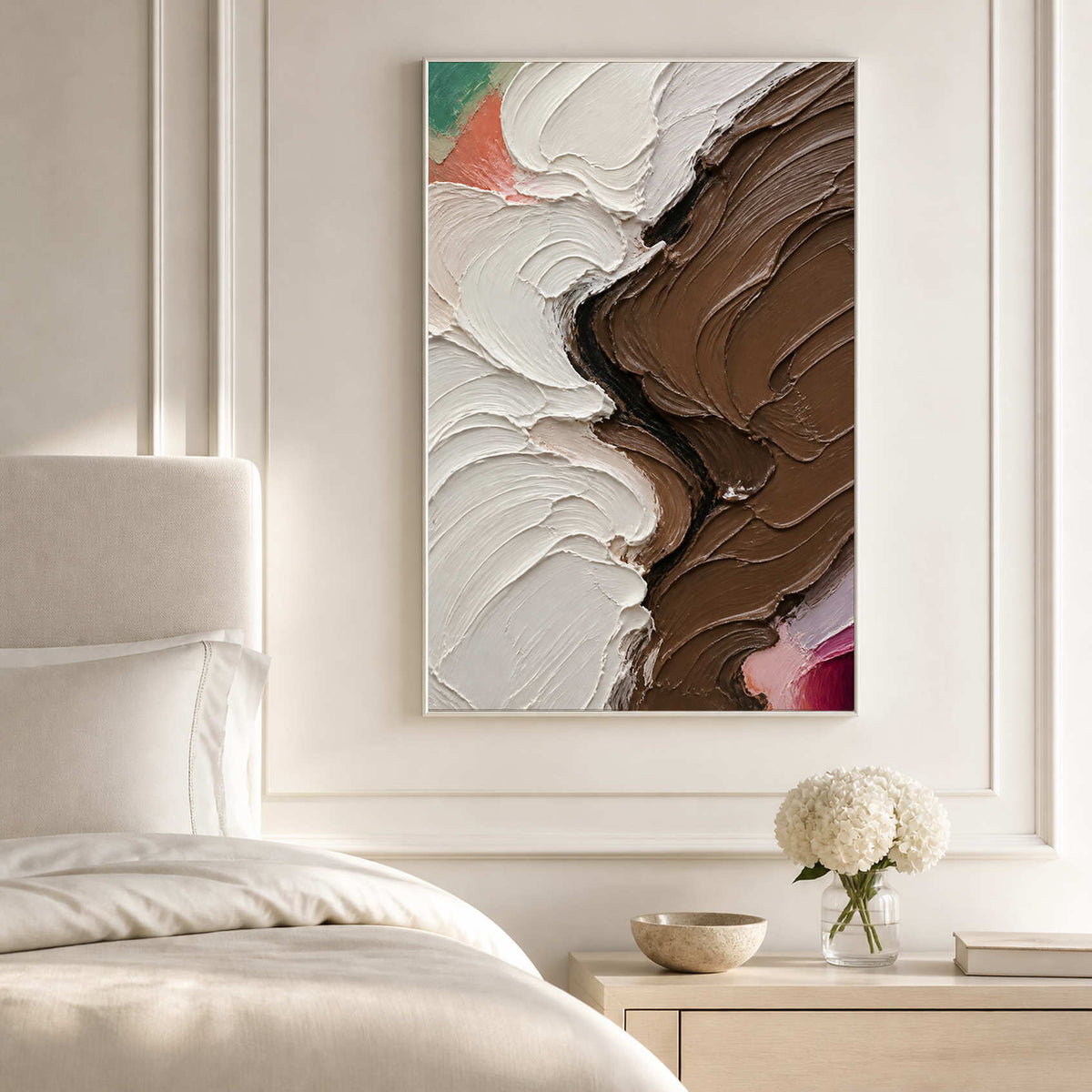 Sculptural ivory and brown abstract canvas above a bright neutral bed.