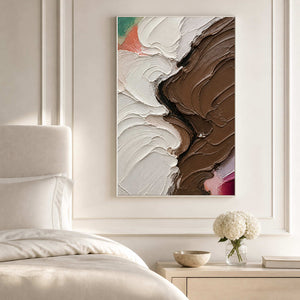 Sculptural ivory and brown abstract canvas above a bright neutral bed.