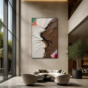 Vertical neutral abstract art displayed in a spacious contemporary hotel lobby.