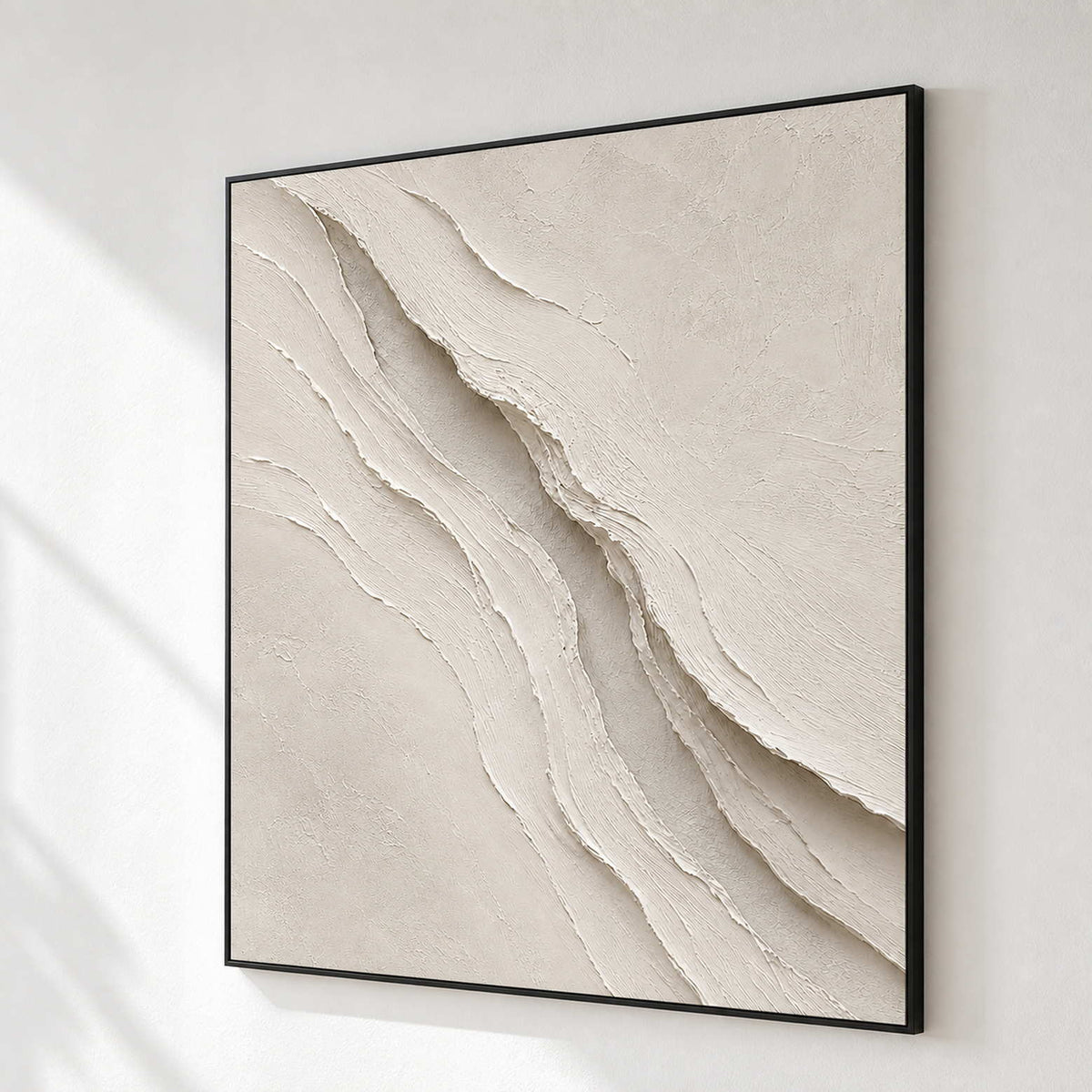 Ivory relief wall art shown from the side on a modern gallery wall.